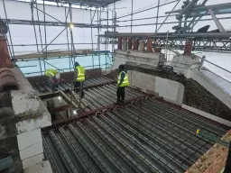 Metal decking and reinforcement installation in progress